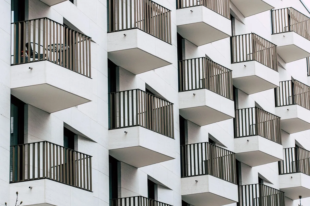 Modern apartment building with mixed siding materials showing engineered wood and fiber cement