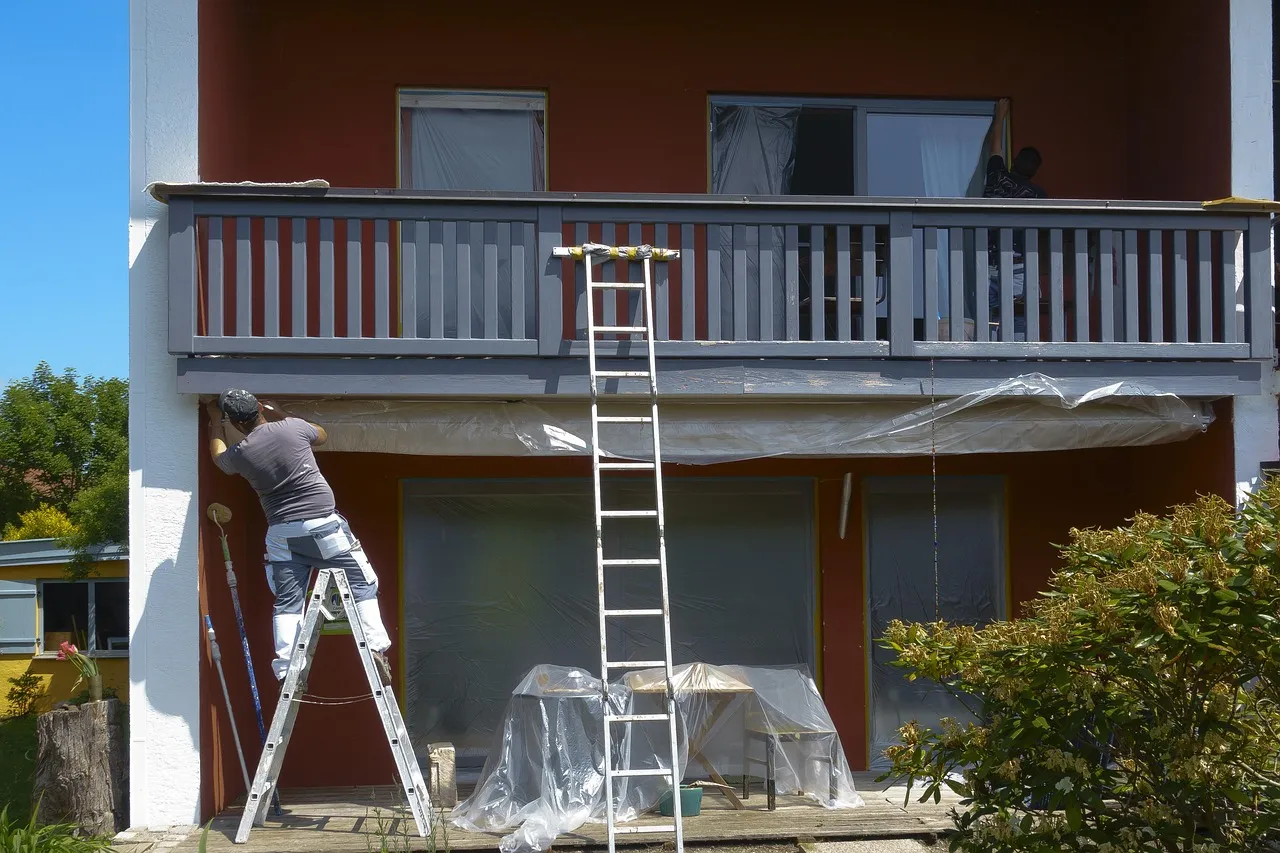 Professional exterior painting crew working on a Minnesota home during ideal fall weather conditions