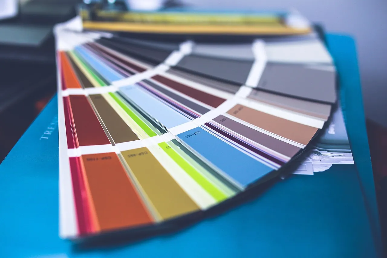 Homeowner using a tablet color visualizer app to preview exterior paint colors on their Minnesota home