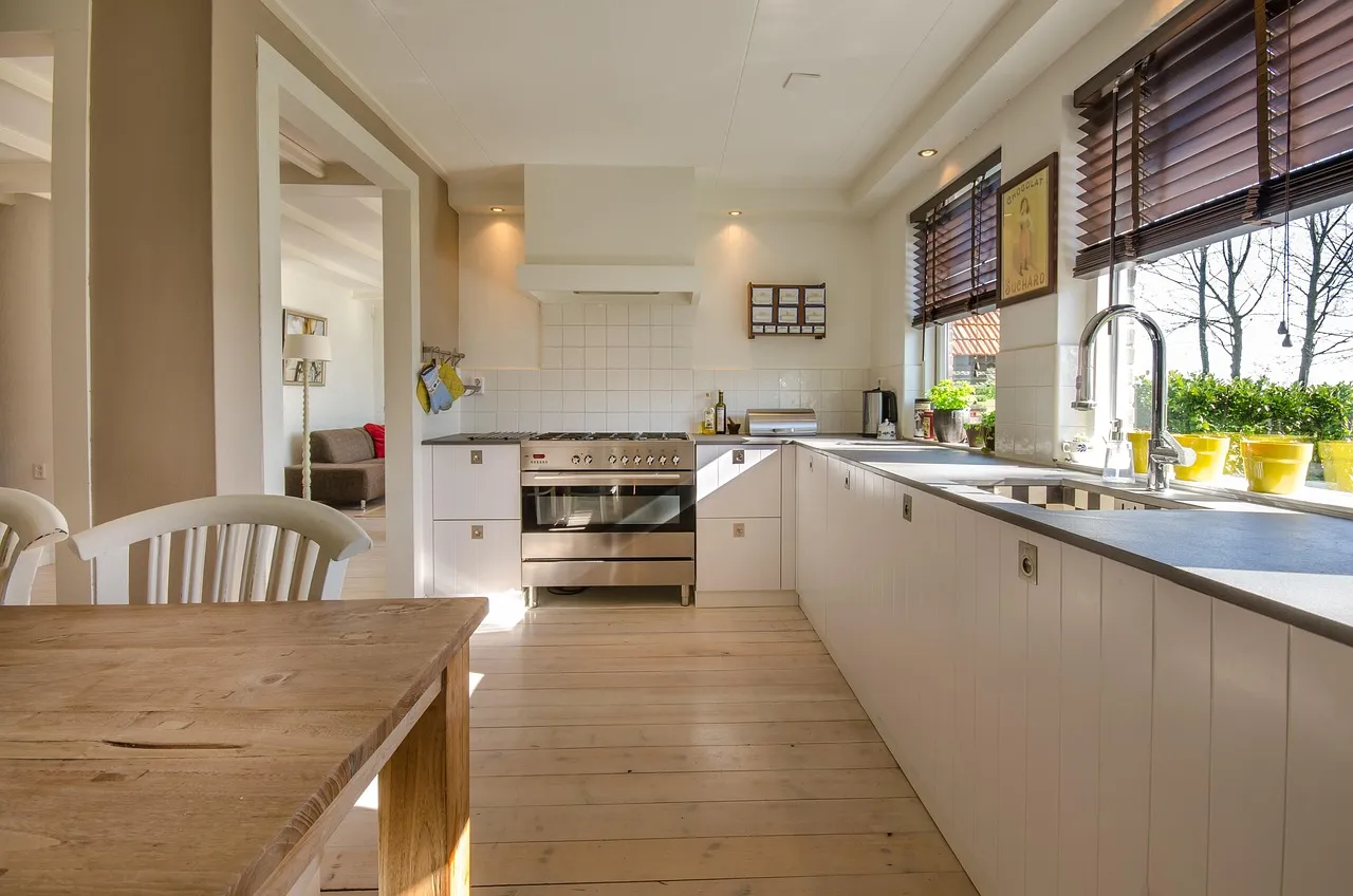 Beautiful kitchen garden window filled with fresh herbs and plants above a farmhouse sink