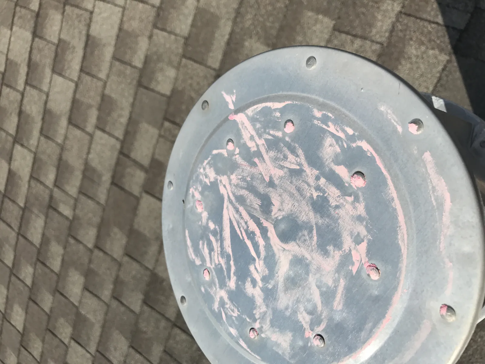 Hail damage on metal roof flashing with chalk-marked impact points during a professional storm damage assessment