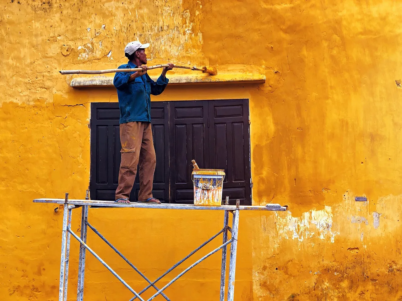 Professional lead paint testing being performed on exterior of older Minnesota home using XRF analyzer