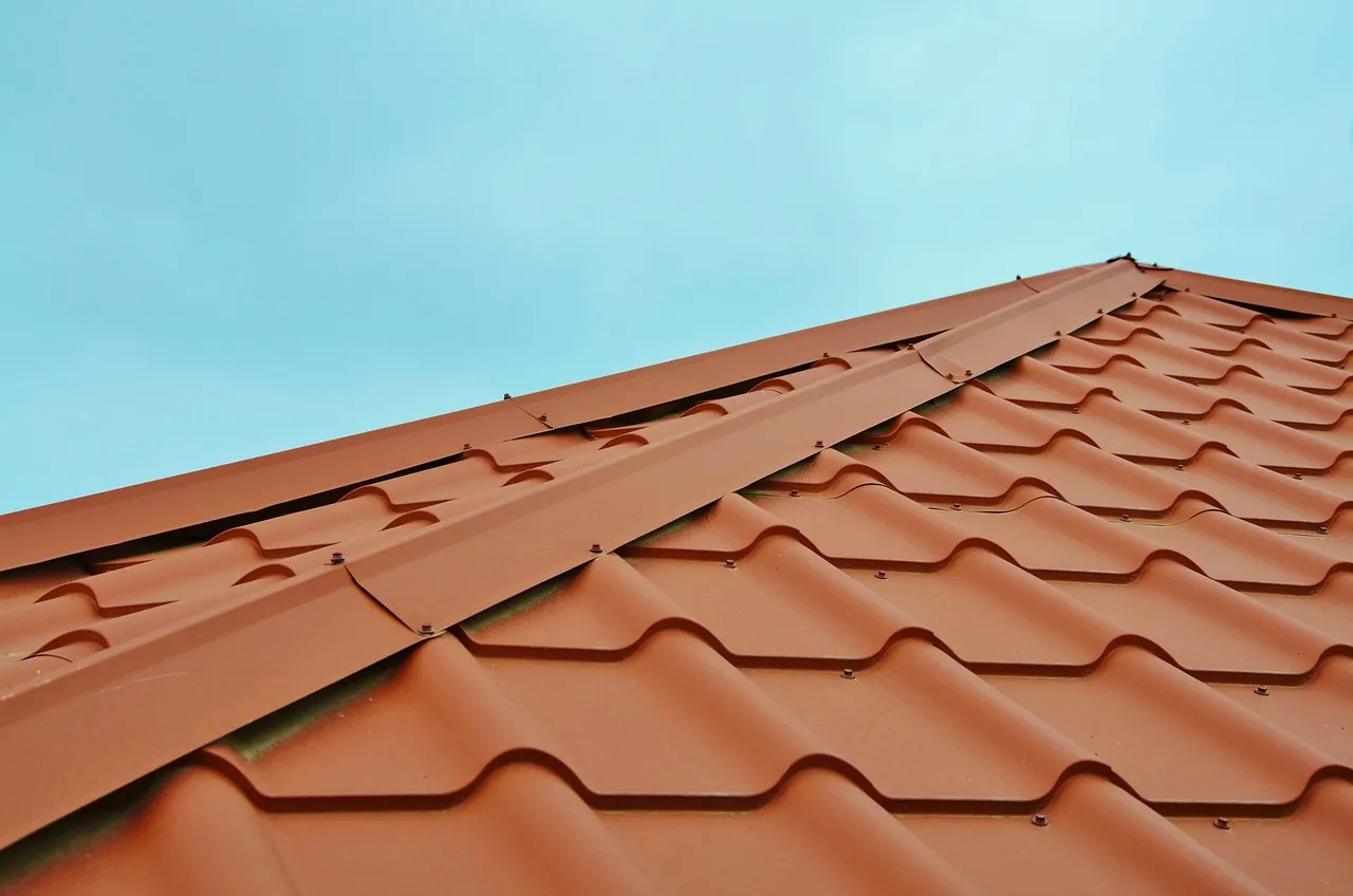 Split comparison showing metal standing seam roof and asphalt shingle roof on Minnesota homes