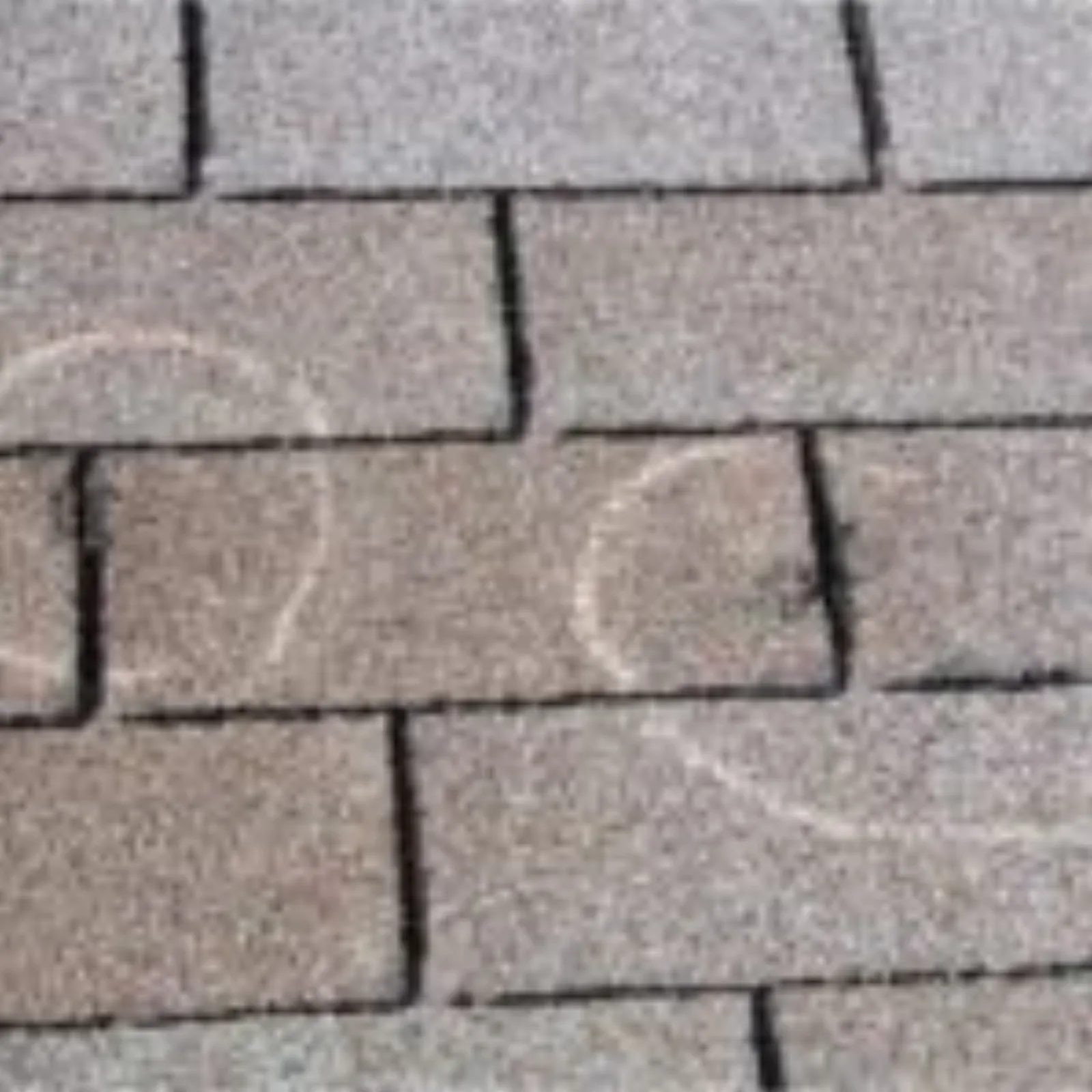 Multiple chalk-circled hail damage impacts on roof shingles showing pattern of storm damage for insurance documentation