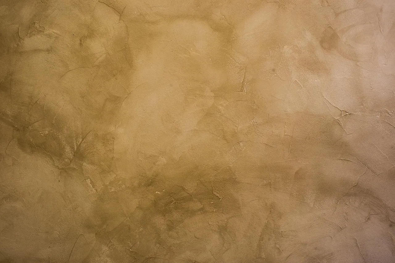 Stucco exterior wall being professionally painted on a Minnesota home