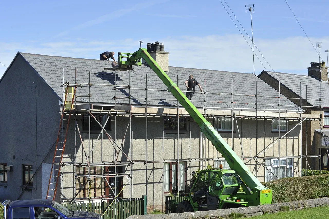 Roofing crew installing new asphalt shingles on a Minnesota home during a roof replacement project