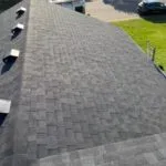 Close-up of architectural asphalt shingles on completed roof by Weatherguard Construction showing dimensional profile and color