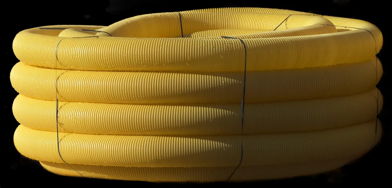 Underground gutter drainage pipe installation with pop-up emitter directing water away from home