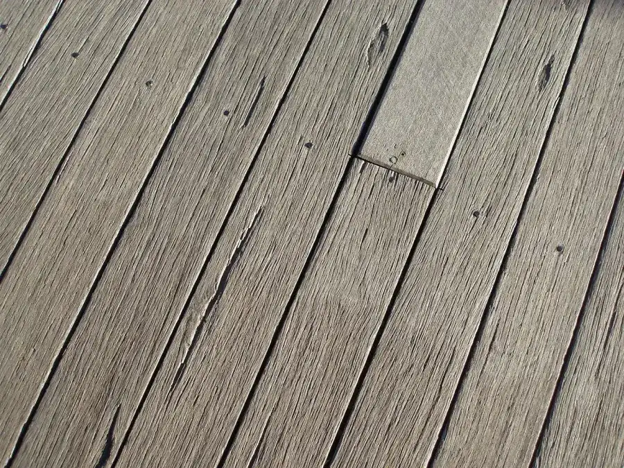 Wolf Serenity PVC decking boards in a warm wood tone installed on a Minnesota backyard deck