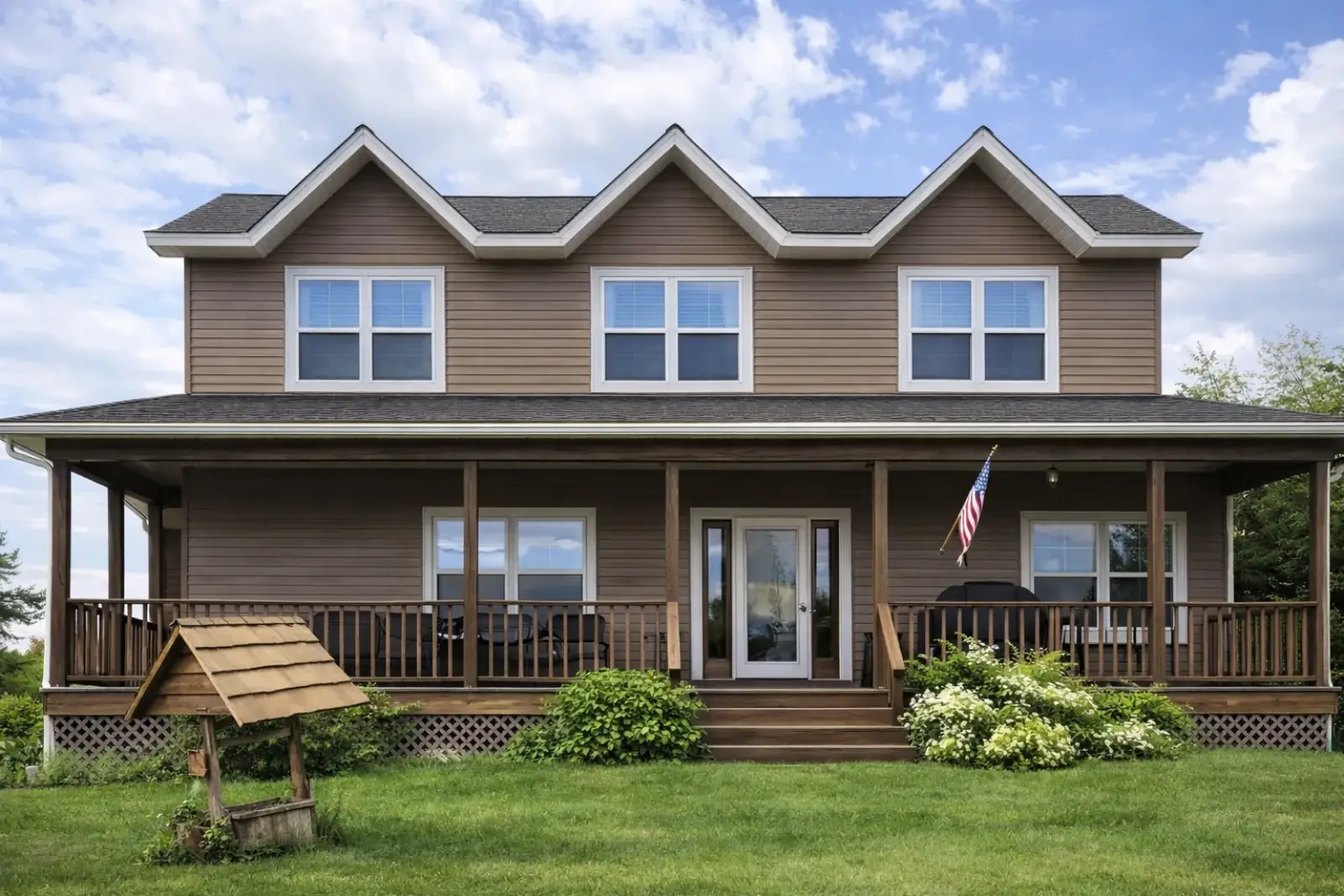 Brown Siding Home Wraparound Porch American Flag