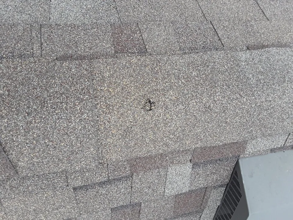 Roof damage near pipe vent boot from storm - inspection photo