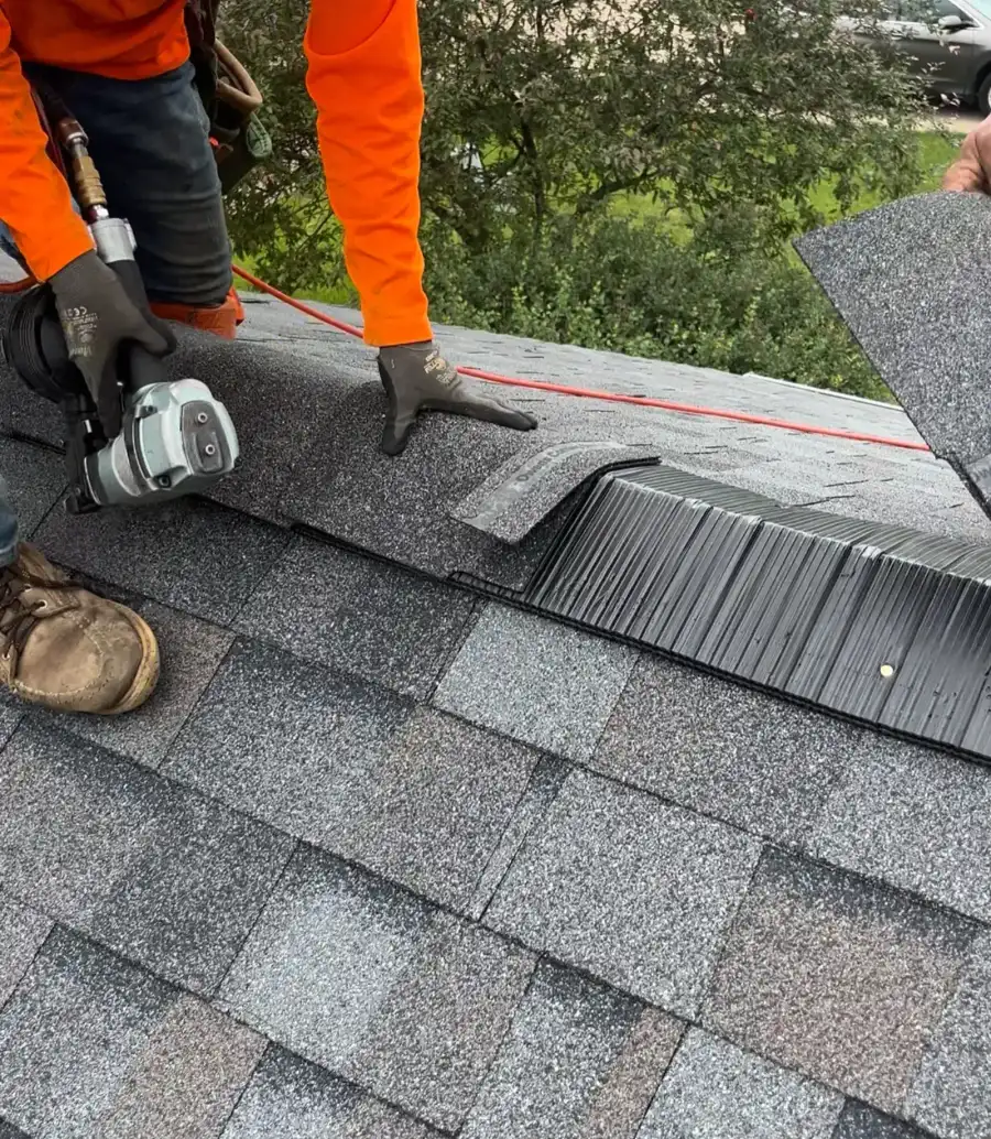 Roofer Installing Ridge Vent Nail Gun Close Up