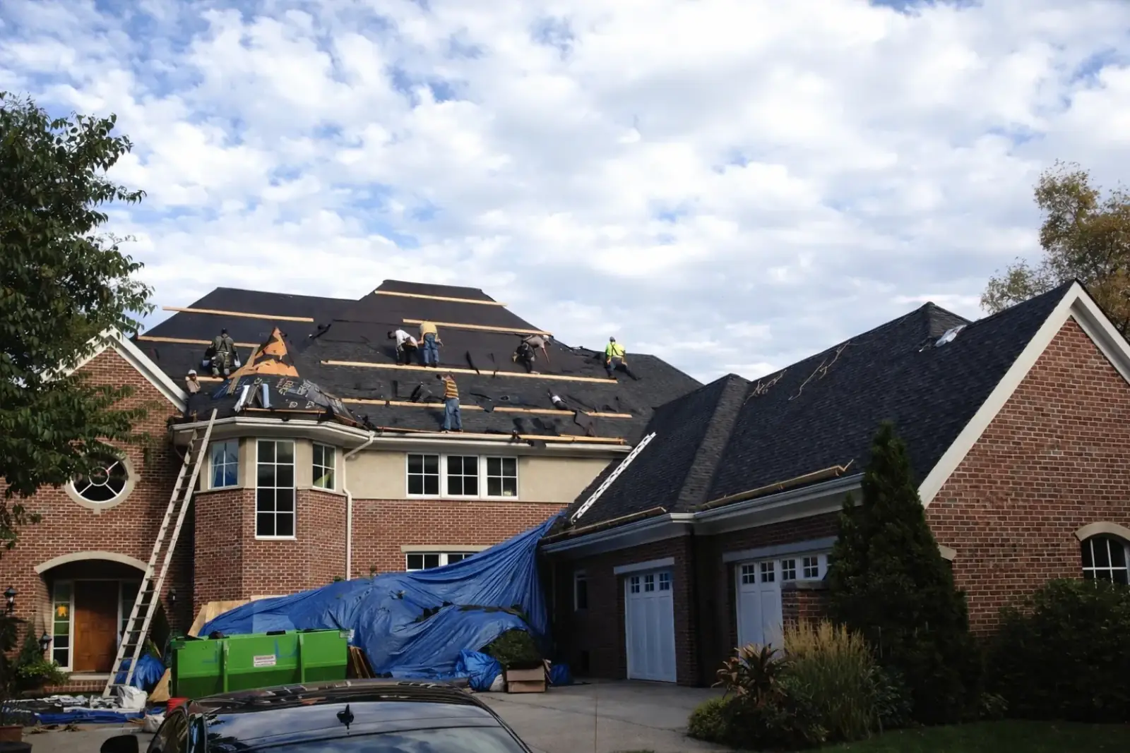 Weatherguard roofing crew installing a new roof on a residential home