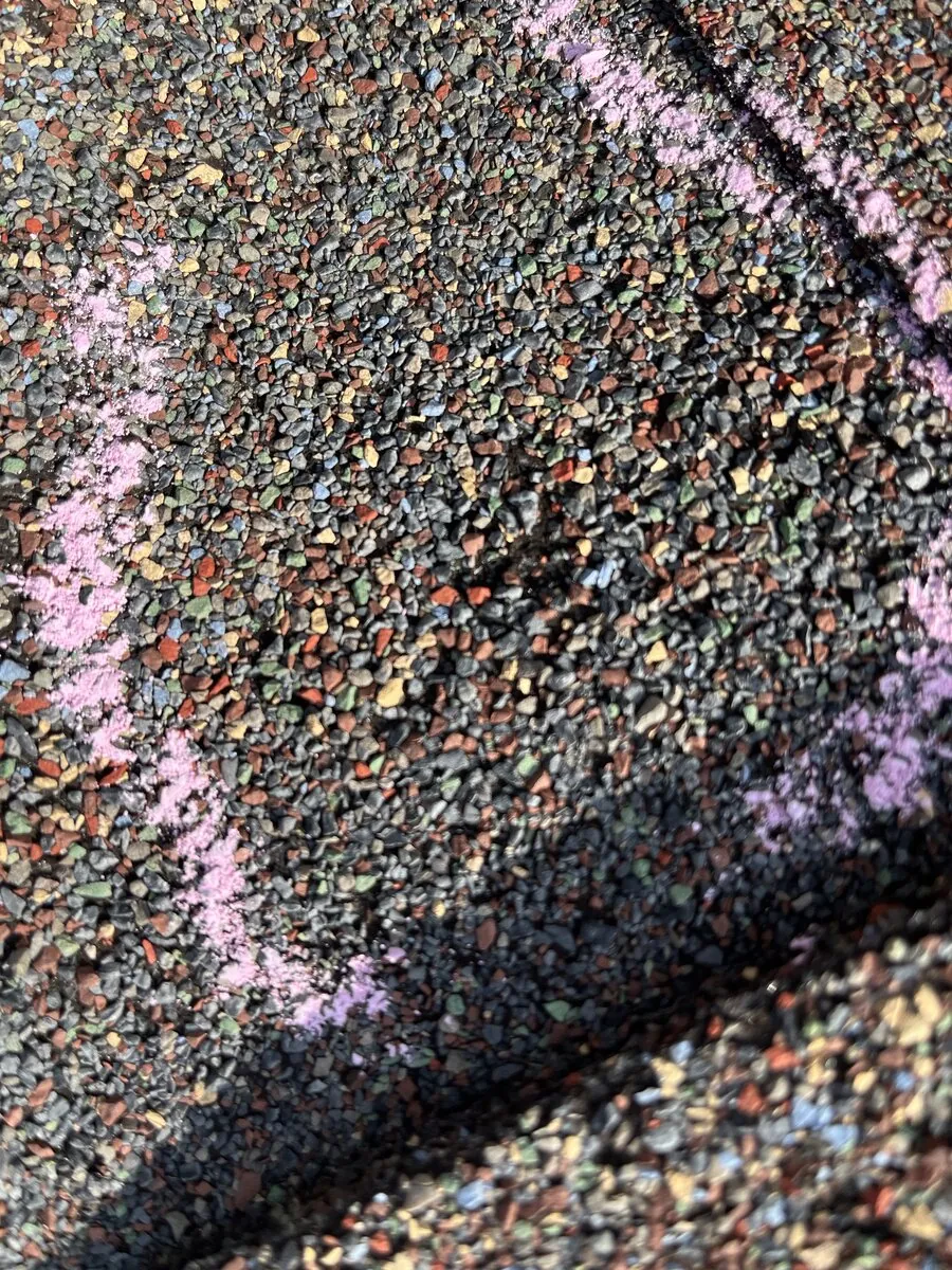 Close-up of shingle granule loss and hail impact damage