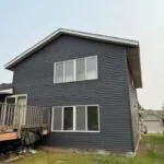 Beige house after complete siding replacement by Weatherguard Construction